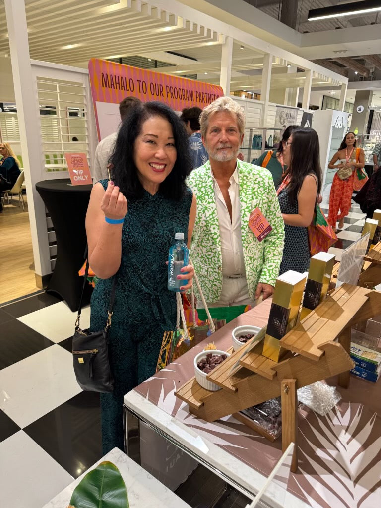 Two people standing in a store with a display of snacks and drinks.