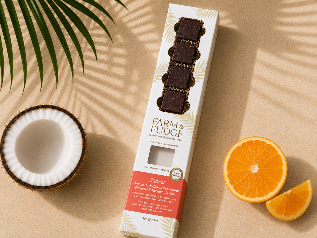 image Box of Farm Fudge Sunset flavor on a beige surface with coconut and orange slices.