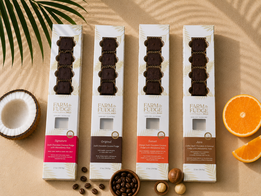 image Four boxes of Farm Fudge chocolate packaging on a beige surface with fruits and nuts.
